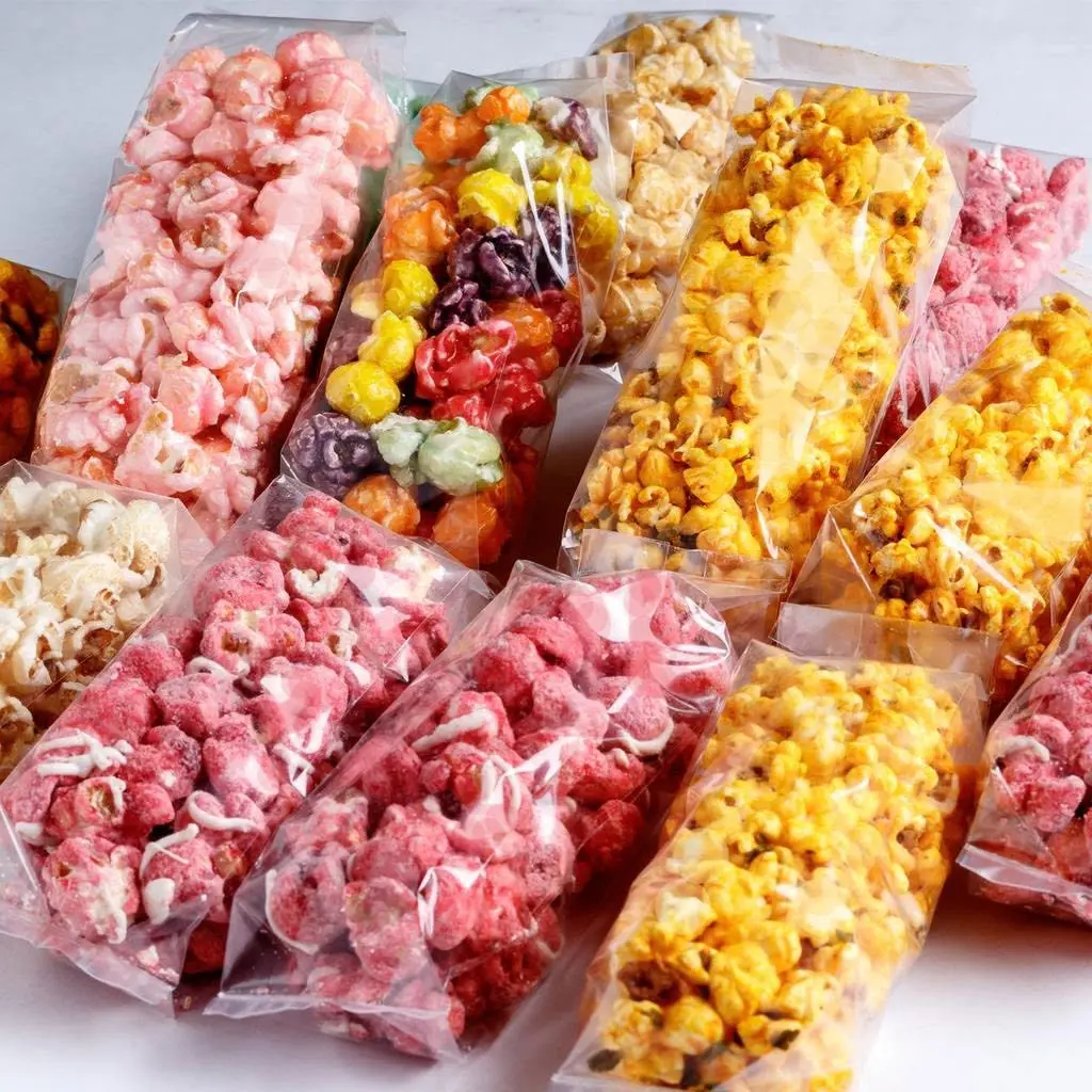 Bags of gourmet popcorn in caramel, cheddar, strawberry and rainbow flavors